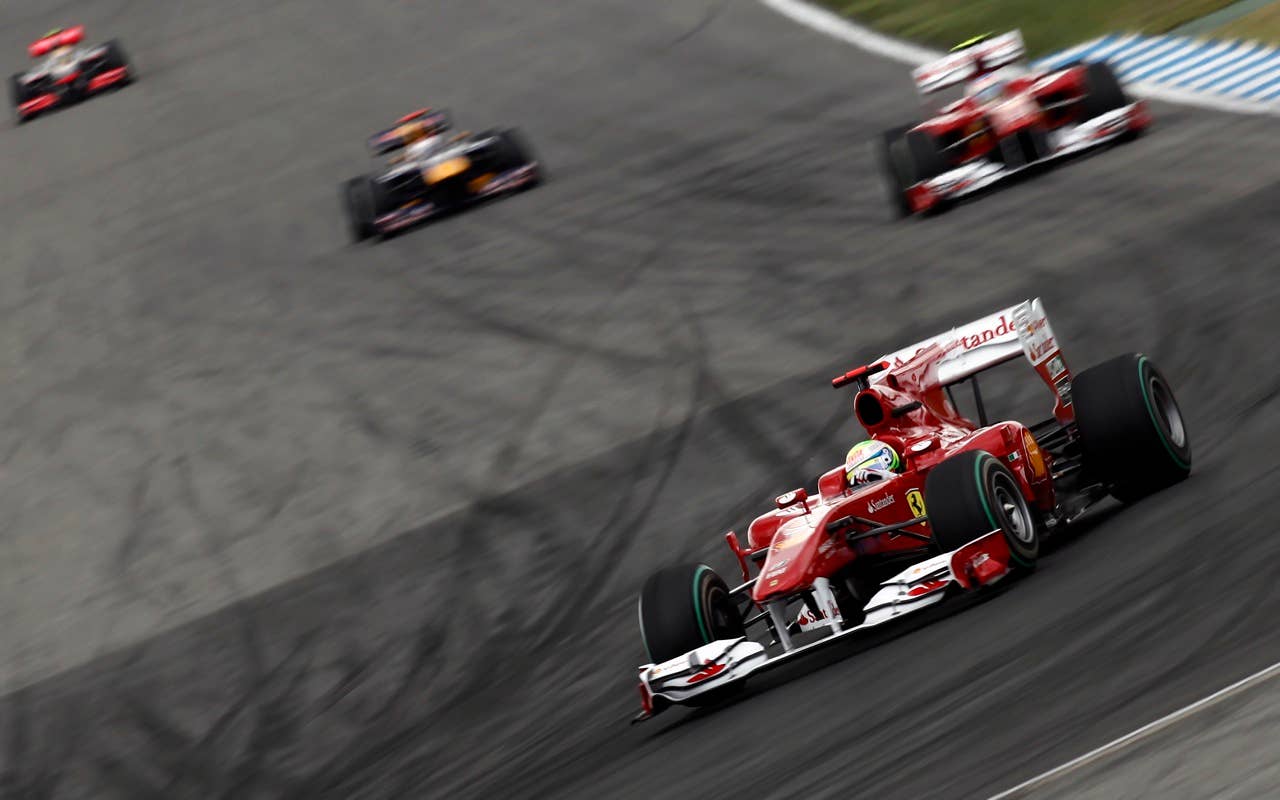 Ferrari's Brazilian  Felipe Massa drives ahead of Ferrari's Spanish driver Fernando Alonso and Red Bull's German driver Sebastian Vettel at the Hockenheimring circuit on July 25, 2010 in Hockenheim, during the Formula One German Grand Prix.            AFP PHOTO / GUILLAUME BAPTISTE (Photo credit should read GUILLAUME BAPTISTE/AFP/Getty Images)