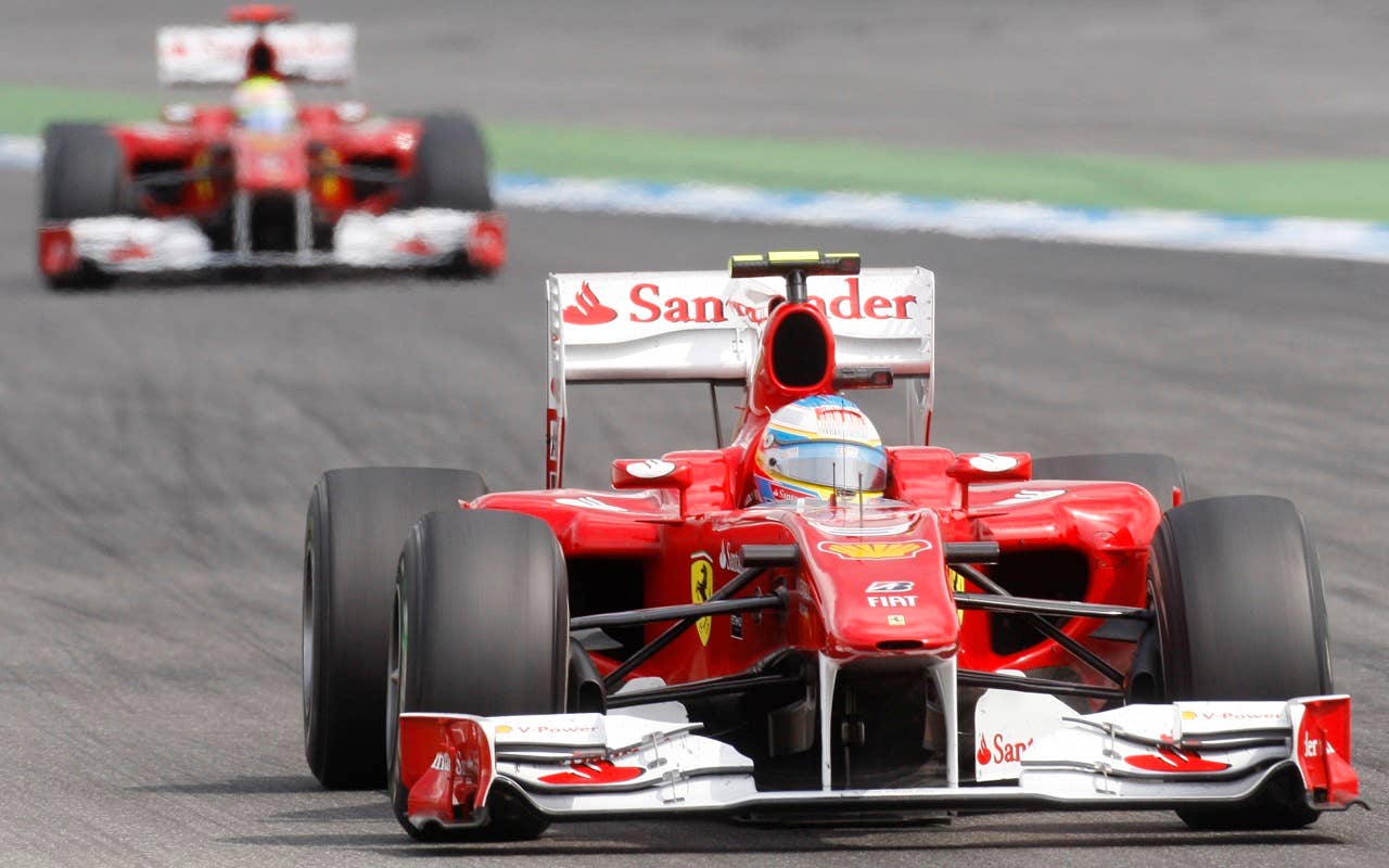 Ferrari Formula One driver Fernando Alsonso from Spain leads team mate Felipe Massa from Brazil to win the German F1 race at the race track in Hockenheim,  Germany, Sunday, July 25, 2010. (AP Photo/Michael Probst)