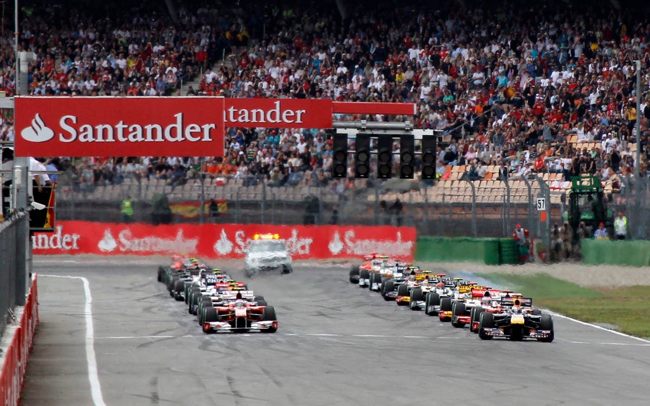 Red Bull Formula One driver Sebastian Vettel of Germany, right,  leads the pack at the start to the German Formula One Grand Prix in Hockenheim, Germany, Sunday, July 25, 2010. (AP Photo/Matthias Schrader)
