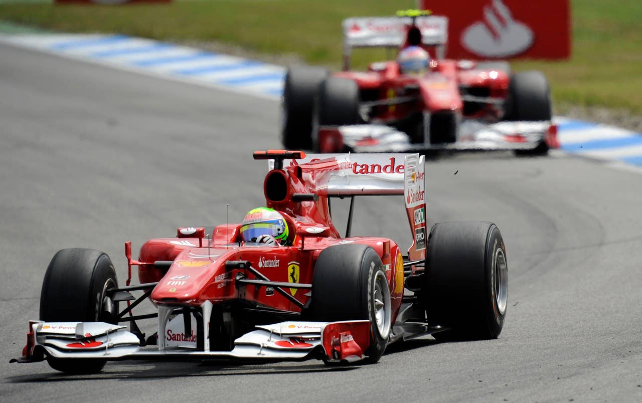 Ferrari's  Felipe Massa of Brazil  leads in front of teammate Fernando Alonso of Spain  at the first turn of the German Formula One Grand Prix in Hockenheim, Germany,  Sunday, July 25, 2010. (AP Photo/Martin Meissner)