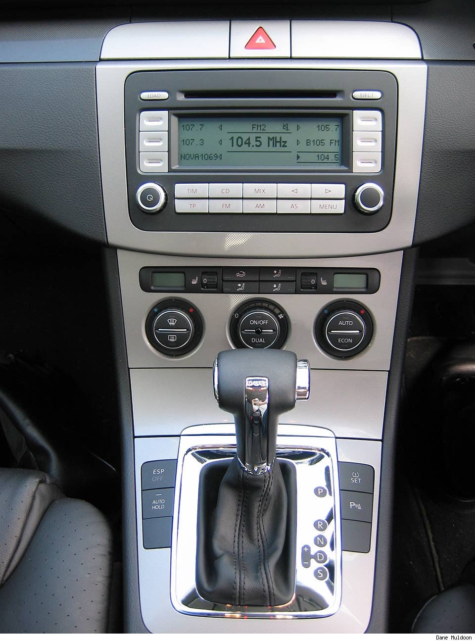 Carbon fibre like silver finish is slick without screaming "I cut down a forest to bring you this wood finish". Coin trays either side of the hazard light are useful