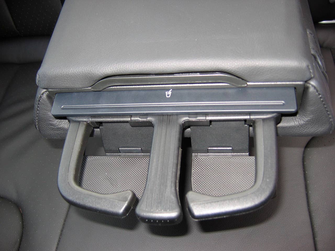 More impressive than the limited storage in the rear arm rest is the cool pop-out drinks holders