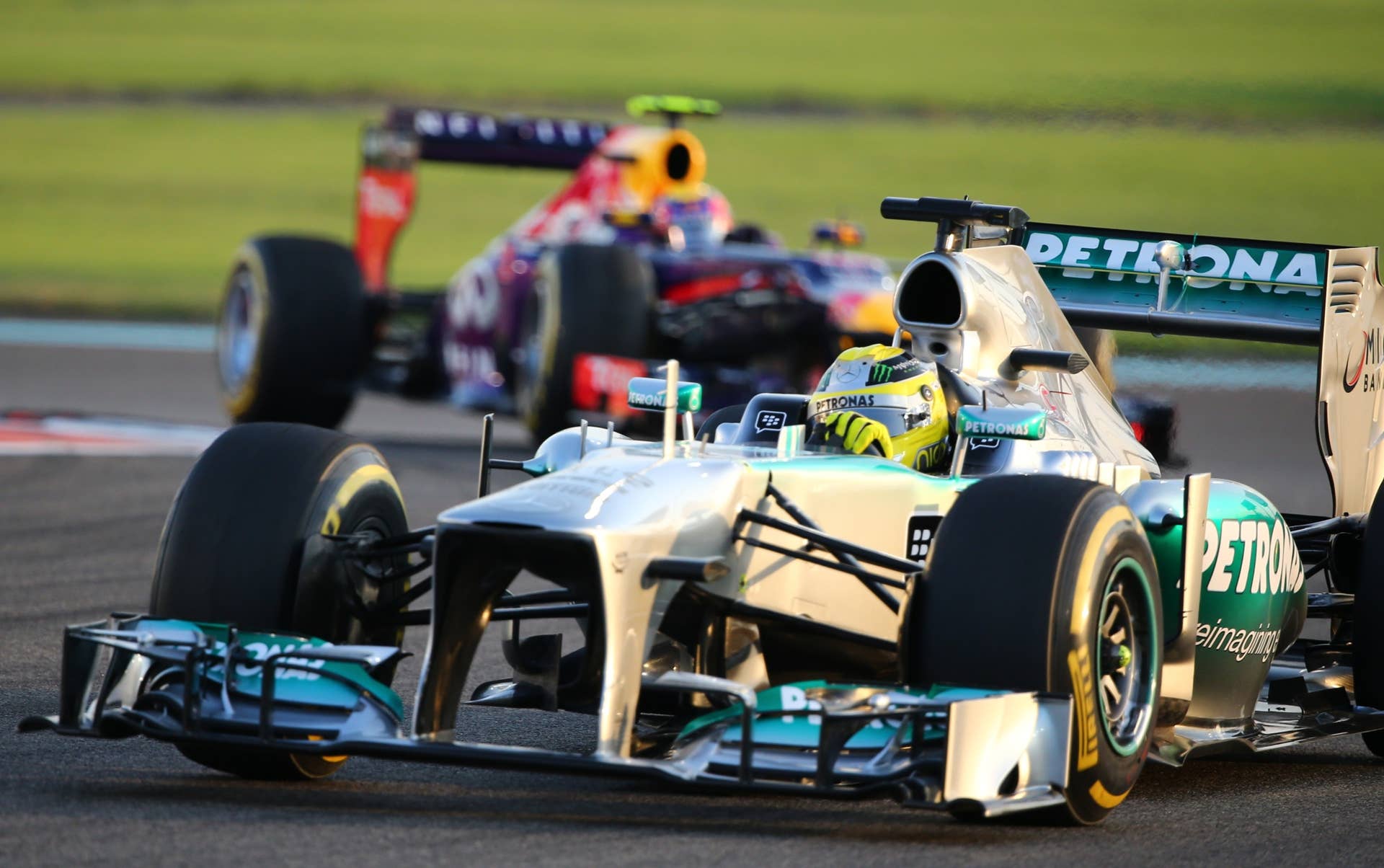 Red Bull Racing's Australian driver Mark Webber and Mercedes'  German driver Nico Rosberg drives at the Yas Marina circuit in Abu Dhabi on November 3, 2013 during the Abu Dhabi Formula One Grand Prix.    AFP PHOTO / MARWAN NAAMANI        (Photo credit should read MARWAN NAAMANI/AFP/Getty Images)