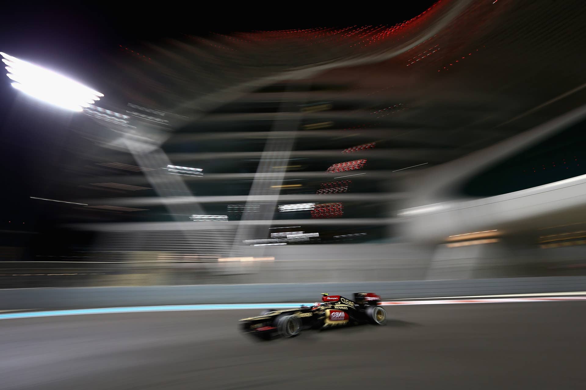 ABU DHABI, UNITED ARAB EMIRATES - NOVEMBER 03:  Romain Grosjean of France and Lotus drives during the Abu Dhabi Formula One Grand Prix at the Yas Marina Circuit on November 3, 2013 in Abu Dhabi, United Arab Emirates.  (Photo by Clive Mason/Getty Images)
