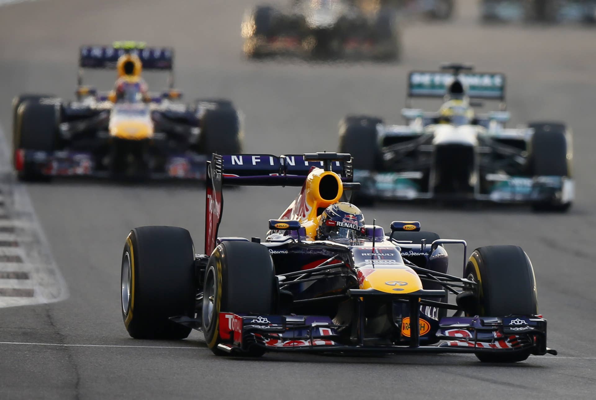 Red Bull Racing's Australian driver Mark Webber, Red Bull Racing's German driver Sebastian Vettel and Mercedes'  German driver Nico Rosberg drive at the Yas Marina circuit in Abu Dhabi on November 3, 2013 during the Abu Dhabi Formula One Grand Prix.  AFP PHOTO / KARIM SAHIB        (Photo credit should read KARIM SAHIB/AFP/Getty Images)