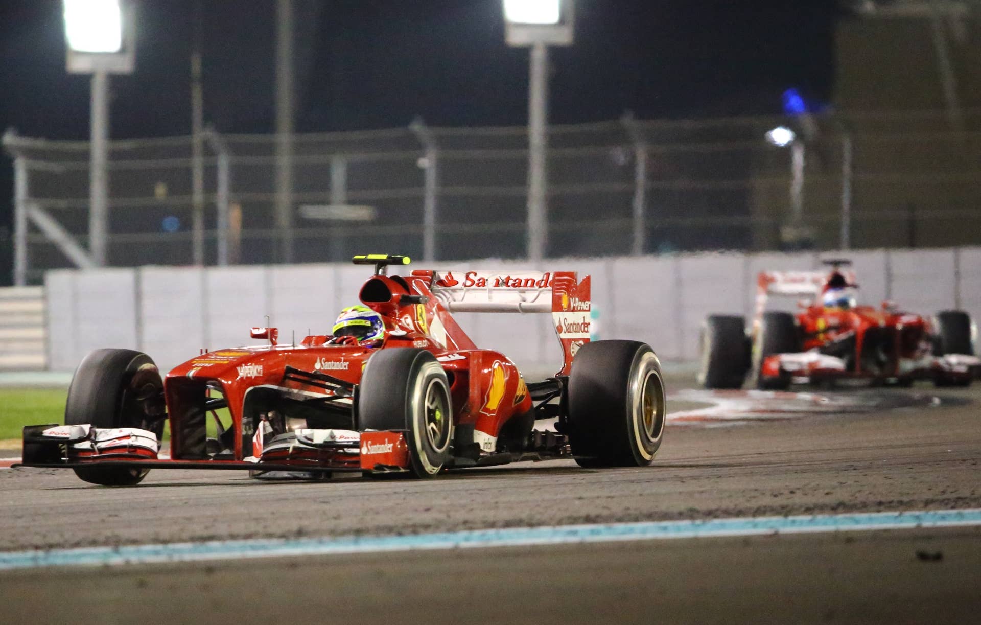(L to R) Ferrari's Brazilian driver Felipe Massa  and Ferrari's Spanish driver Fernando Alonso drives at the Yas Marina circuit in Abu Dhabi on November 3, 2013 during the Abu Dhabi Formula One Grand Prix.    AFP PHOTO / MARWAN NAAMANI        (Photo credit should read MARWAN NAAMANI/AFP/Getty Images)