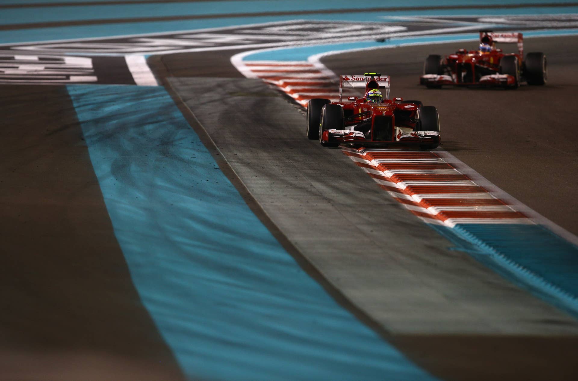 ABU DHABI, UNITED ARAB EMIRATES - NOVEMBER 03:  Felipe Massa of Brazil and Ferrari leads from Fernando Alonso of Spain and Ferrari during the Abu Dhabi Formula One Grand Prix at the Yas Marina Circuit on November 3, 2013 in Abu Dhabi, United Arab Emirates.  (Photo by Paul Gilham/Getty Images)
