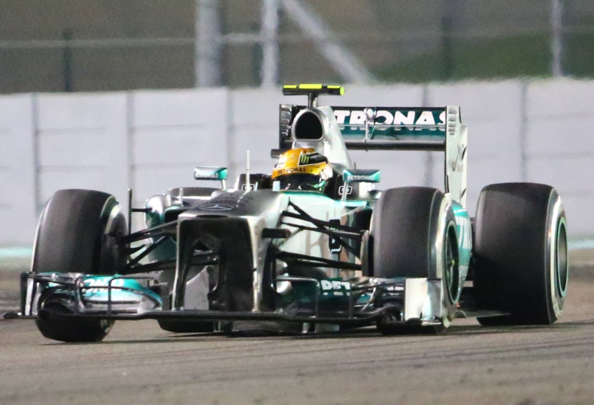 (L to R)Mercedes'  British driver Lewis Hamilton drives at the Yas Marina circuit in Abu Dhabi on November 3, 2013 during the Abu Dhabi Formula One Grand Prix.    AFP PHOTO / MARWAN NAAMANI        (Photo credit should read MARWAN NAAMANI/AFP/Getty Images)