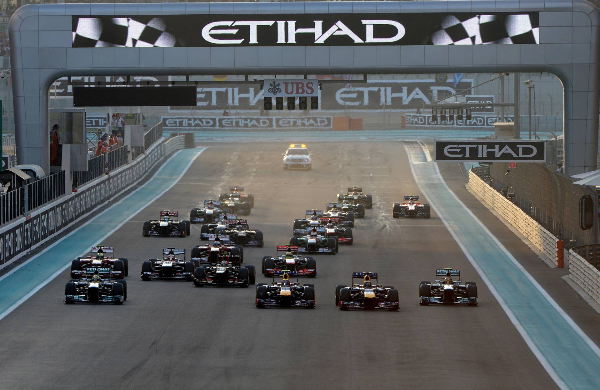 Red Bull Racing's German driver Sebastian Vettel (C-R) leads after the start of the Abu Dhabi Formula One Grand Prix at the Yas Marina circuit in Abu Dhabi on November 3, 2013.  AFP PHOTO / TOM GANDOLFINI        (Photo credit should read Tom Gandolfini/AFP/Getty Images)