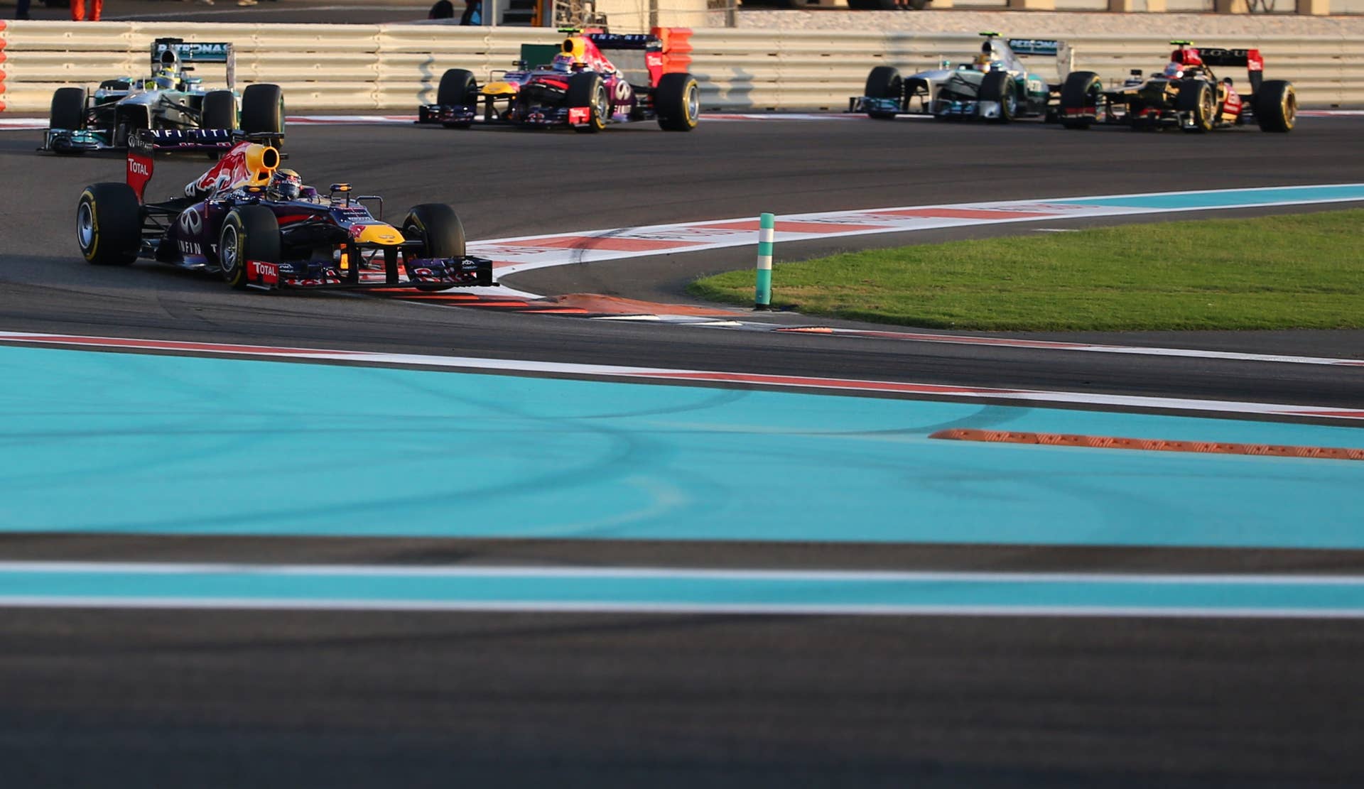 (L to R) Ferrari's Spanish driver Fernando Alonso, Mercedes'  German driver Nico Rosberg, Red Bull Racing's German driver Sebastian Vettel, Red Bull Racing's Australian driver Mark Webber, Mercedes'  British driver Lewis Hamilton and Lotus F1 Team's French driver Romain Grosjean drive at the Yas Marina circuit in Abu Dhabi on November 3, 2013 during the Abu Dhabi Formula One Grand Prix.    AFP PHOTO / MARWAN NAAMANI        (Photo credit should read MARWAN NAAMANI/AFP/Getty Images)
