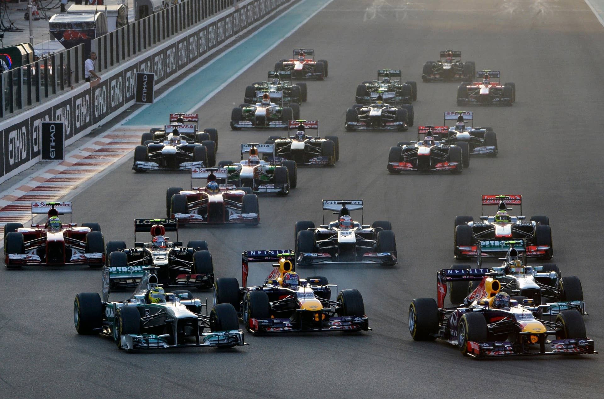 Red Bull Racing's German driver Sebastian Vettel (R) leads after the start of the Abu Dhabi Formula One Grand Prix at the Yas Marina circuit in Abu Dhabi on November 3, 2013.  AFP PHOTO / TOM GANDOLFINI        (Photo credit should read Tom Gandolfini/AFP/Getty Images)