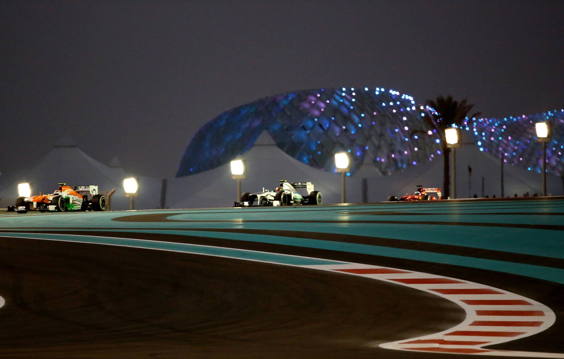 (L to R) Force India's German driver Adrian Sutil, Mercedes'  British driver Lewis Hamilton and Ferrari's Spanish driver Fernando Alonso drives at the Yas Marina circuit in Abu Dhabi on November 3, 2013 during the Abu Dhabi Formula One Grand Prix.    AFP PHOTO / MARWAN NAAMANI        (Photo credit should read MARWAN NAAMANI/AFP/Getty Images)