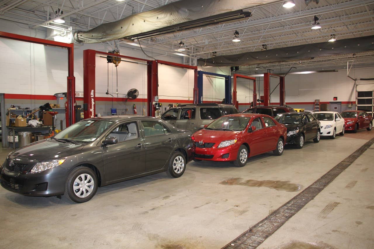 A row of new Corollas in the shop ready to be updated.