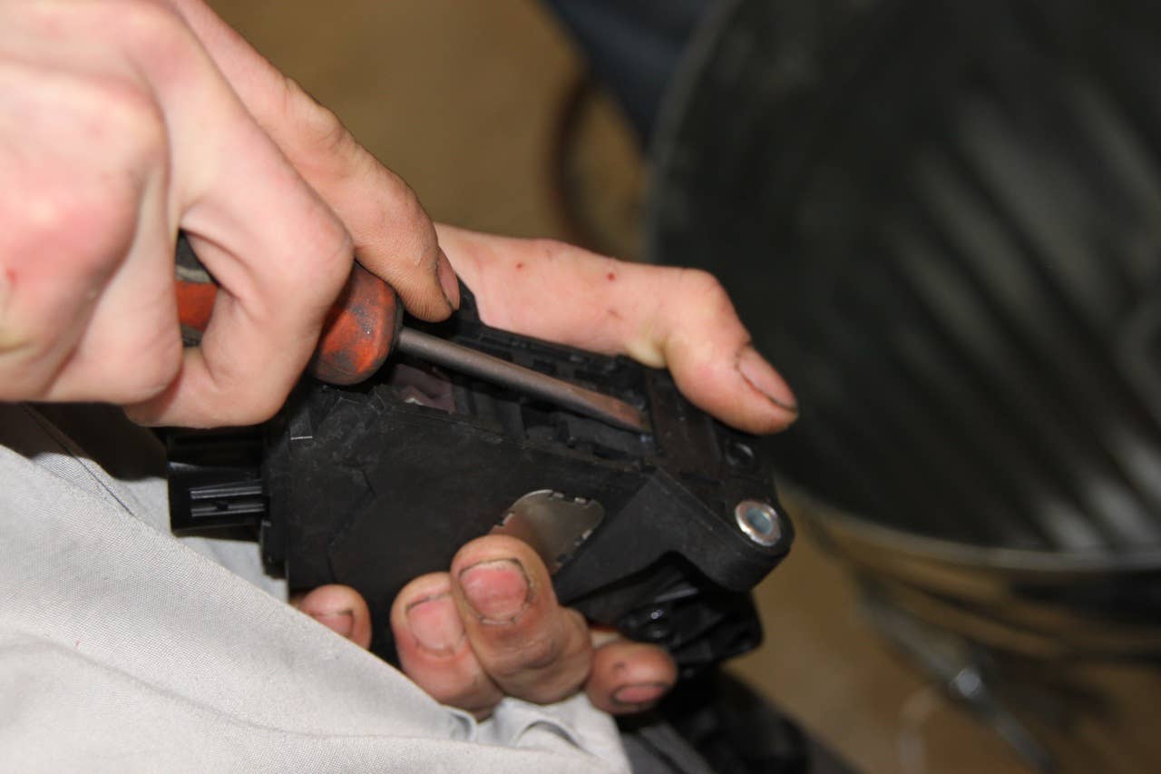 Kropp pries up the friction shoe to allow the shim to be fully seated.