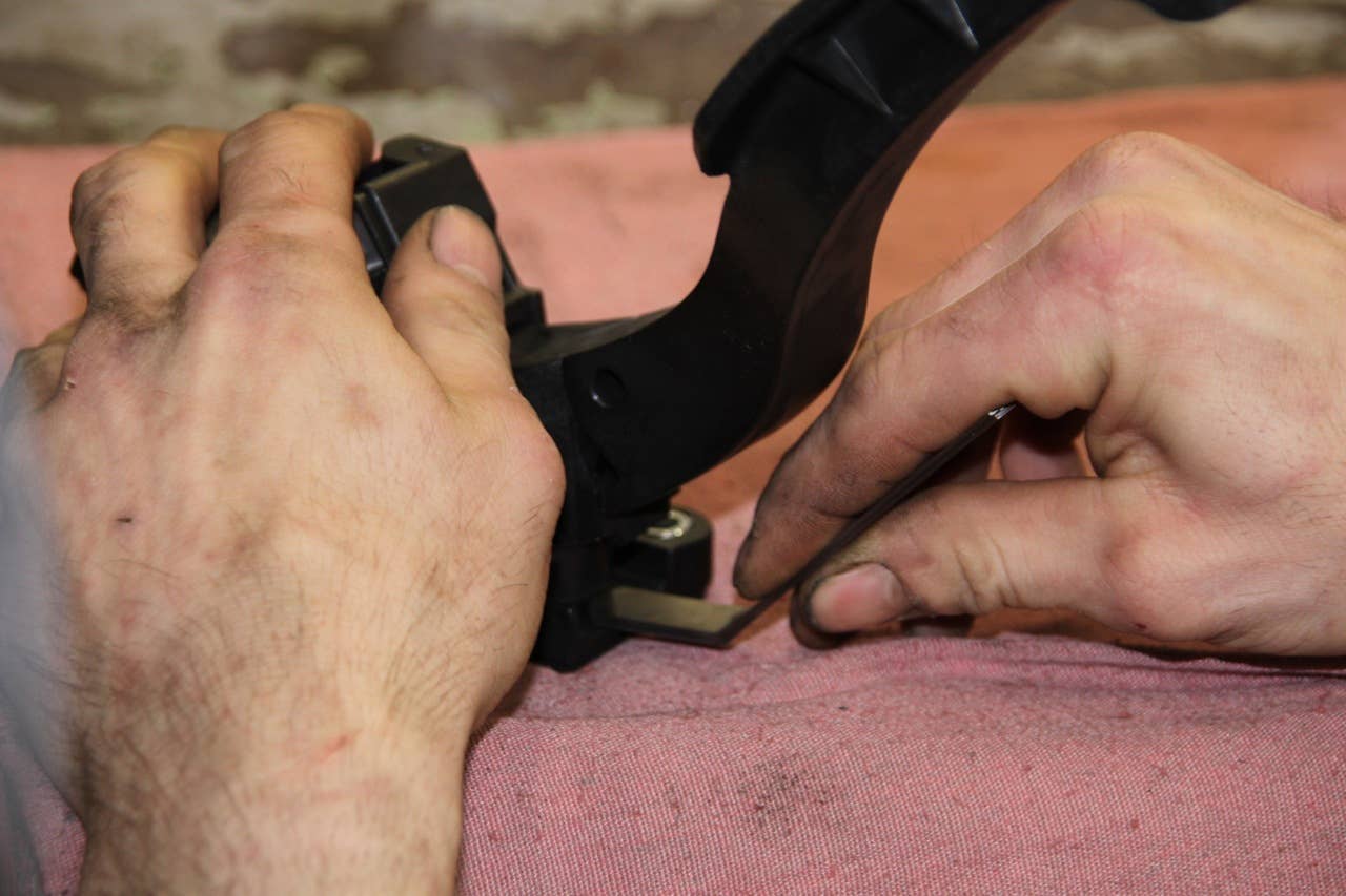Doug Kropp checks the gap in the pedal assembly with the feeler gauge.