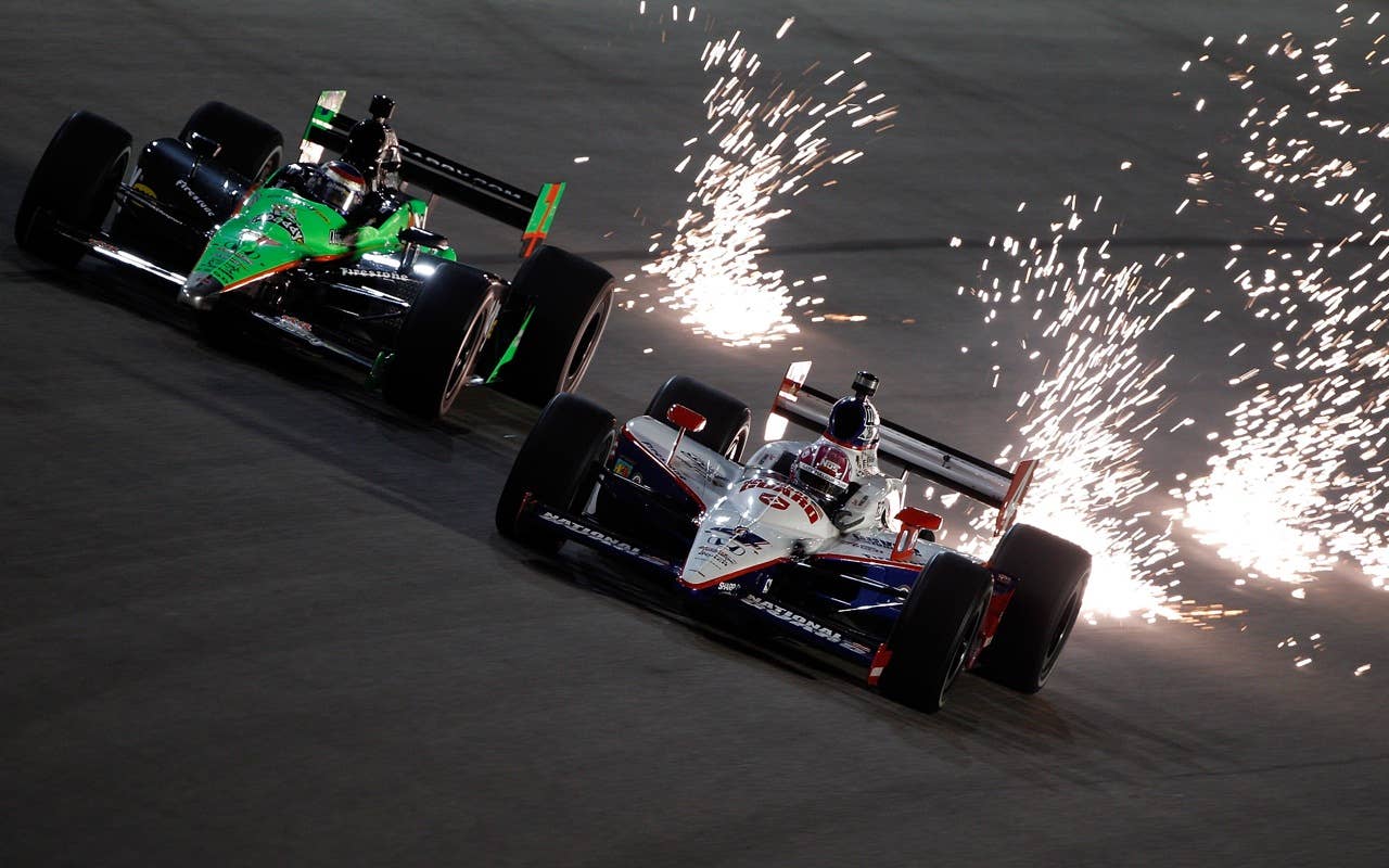 HOMESTEAD, FL - OCTOBER 01:  Danica Patrick, driver of the #7 Team GoDaddy.com Dallara Honda drives next to Dan Wheldon of England, driver of the #4 National Guard Panther Racing Dallara Honda during practice for the IZOD IndyCar Series Cafes do Brasil Indy 300 at Homestead-Miami Speedway on October 1, 2010 in Homestead, Florida.  (Photo by Chris Graythen/Getty Images) *** Local Caption *** Danica Patrick;Dan Wheldon