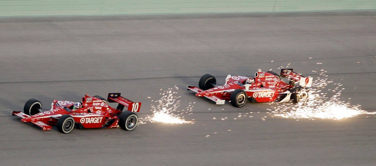 Dario Franchitti (10), of Scotland, is followed by Scott Dixon (9), of New Zealand, as they take Turn 4 during the IndyCar Series' Indy 300 auto race at Homestead-Miami Speedway in Homestead, Fla., Saturday, Oct. 2, 2010. (AP Photo/Alan Diaz)