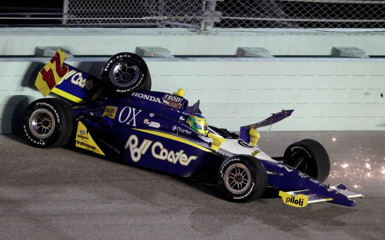 Ana Beatriz, of Brazil, slams into the wall on Turn 4 during the IndyCar Series' Indy 300 auto race at Homestead-Miami Speedway in Homestead, Fla., Saturday, Oct. 2, 2010. (AP Photo/Alan Diaz)