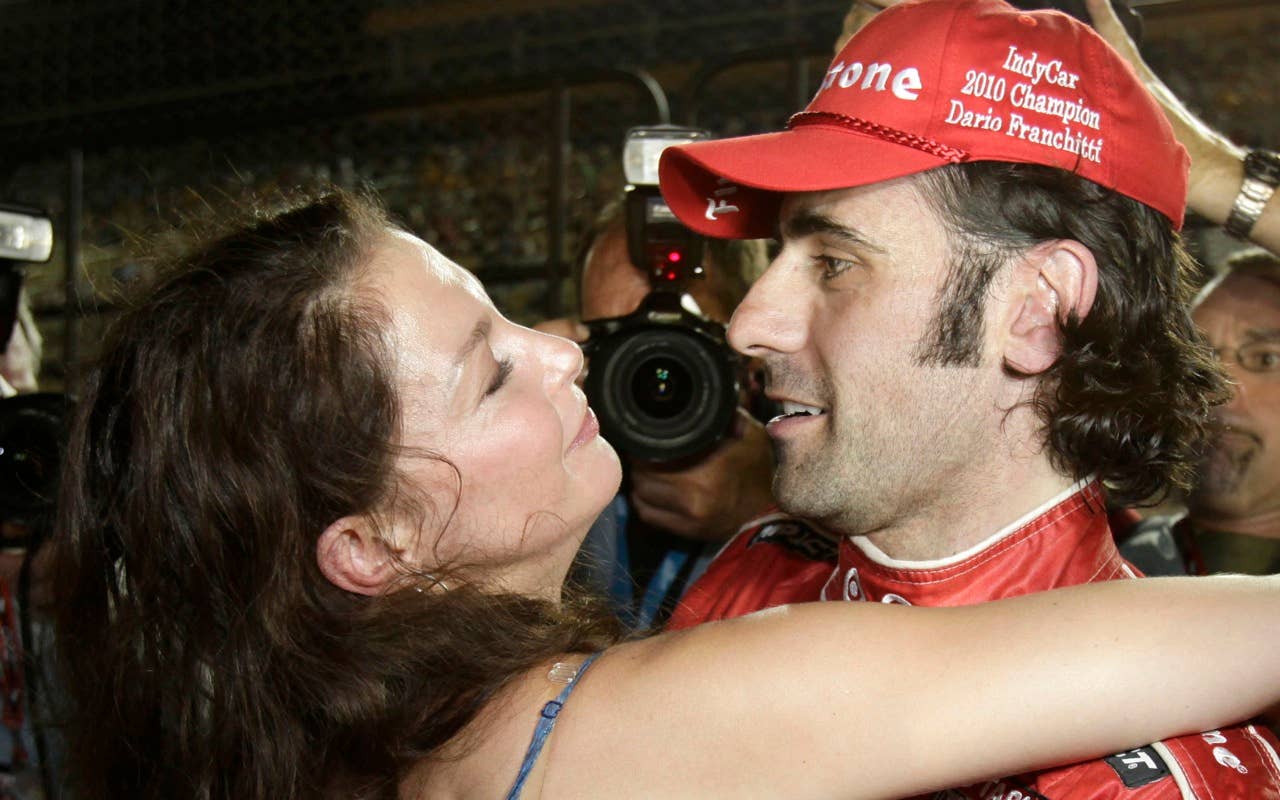 Dario Franchitti, right, of Scotland, receives a hug from his wife, Ashley Judd, after winning the IndyCar Series' season points title at Homestead-Miami Speedway in Homestead, Fla., Saturday, Oct. 2, 2010. (AP Photo/Terry Renna)