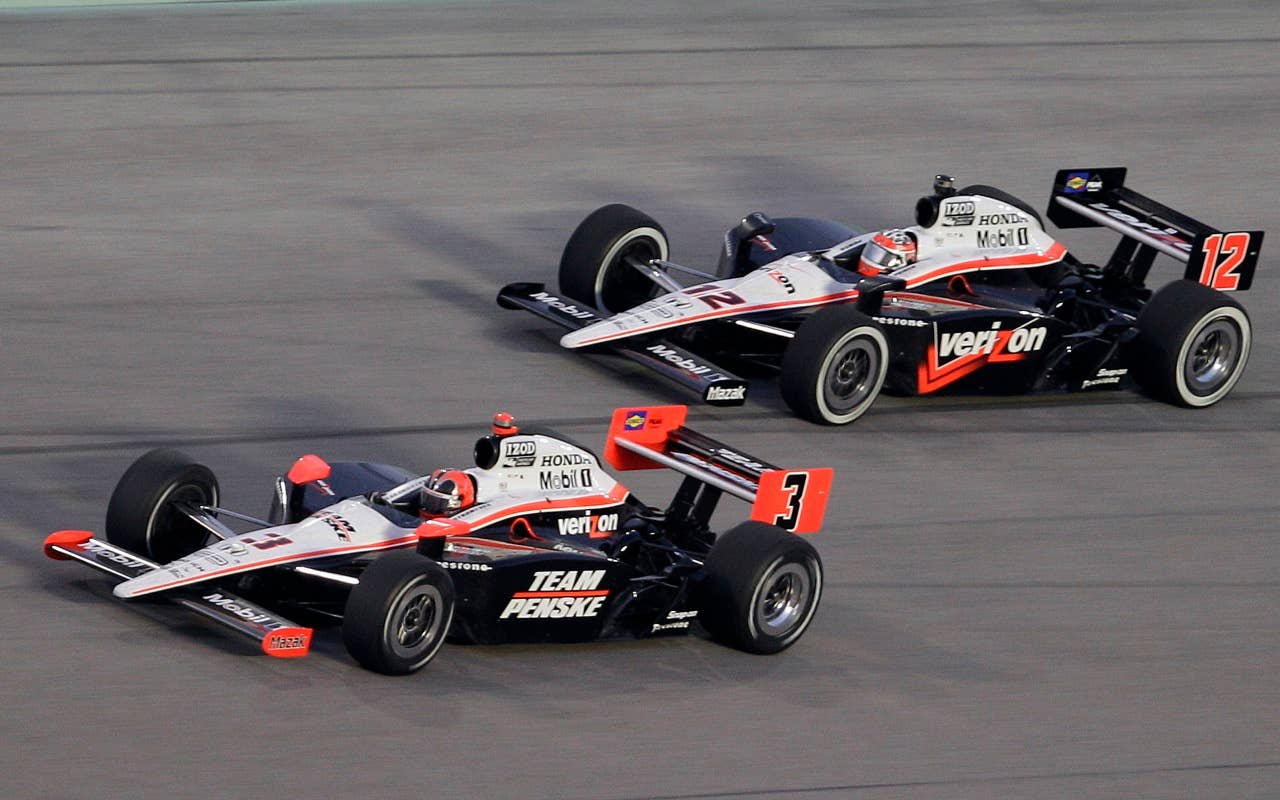 Helio Castroneves (3), of Brazil, followed by Will Power (12), of Australia, take Turn 4 during the IndyCar Series' Indy 300 auto race at Homestead-Miami Speedway in Homestead, Fla., Saturday, Oct. 2, 2010. (AP Photo/Alan Diaz)