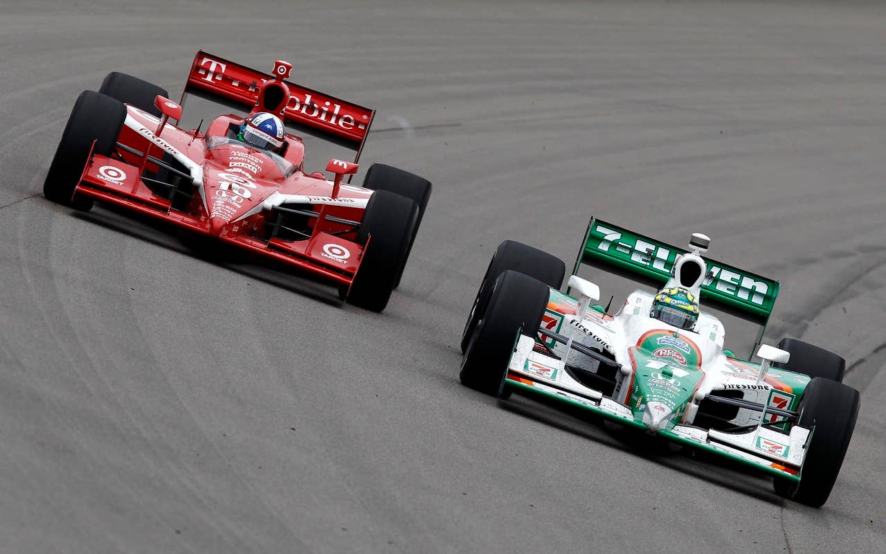 Tony Kanaan of Brazil (R), driver of the #11 7-Eleven Andretti Autosports Dallara Honda, leads Dario Franchitti of Scotland, driver of the #10 Target Chip Ganassi Racing Dallara Honda, during the IRL Indycar Series Iowa Corn Indy 250 on June 20, 2010 in Newton, Iowa.
