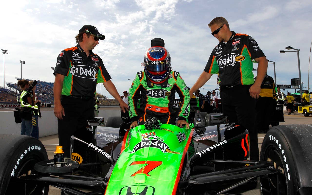 Danica Patrick, driver of the #7 Team Godaddy.com Andretti Autosport Dallara Honda, gets in to her car during qualifying for the IRL Indycar Series Iowa Corn Indy 250 on June 19, 2010 at the Iowa Speedway in Newton, Iowa.