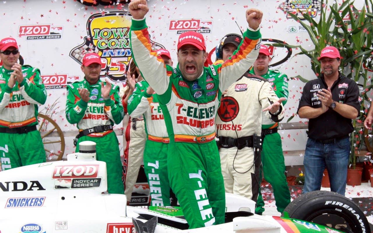 Tony Kanaan, of Brazil, celebrates in victory lane after winning the IndyCar Series' Iowa Corn Indy 250 auto race at Iowa Speedway in Newton, Iowa, Sunday, June 20, 2010. At right rear is car owner Michael Andretti.