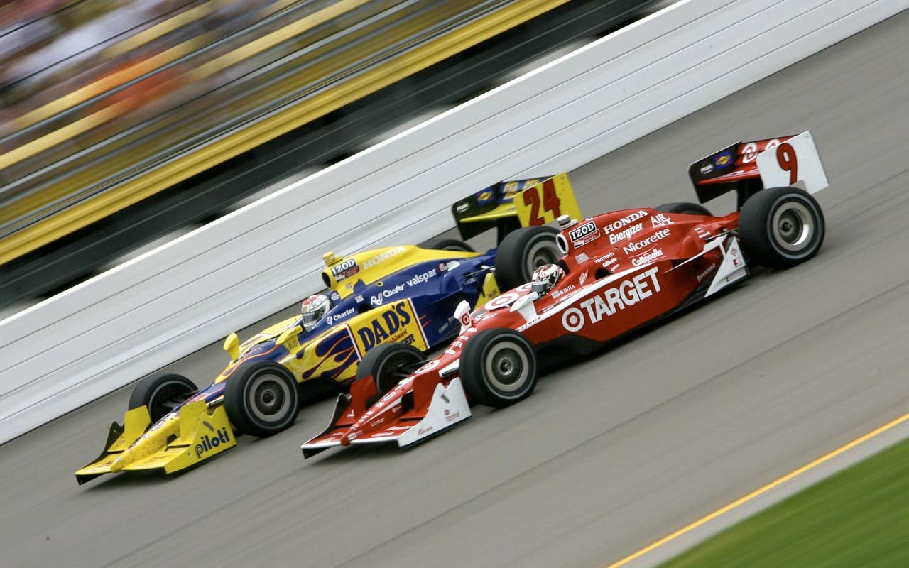 Graham Rahal (L), driver of the #24 Dad's Root Beer Dreyer & Reinbold Racing Dallara Honda, leads Dario Franchitti of Scotland, driver of the #10 Target Chip Ganassi Racing Dallara Honda, during the IRL Indycar Series Iowa Corn Indy 250 on June 20, 2010 in Newton, Iowa.