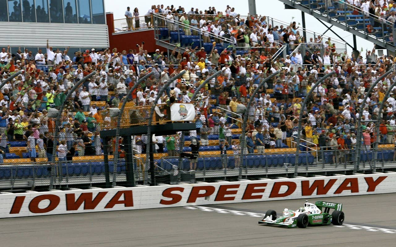 Tony Kanaan of Brazil, driver of the #11 7-Eleven Andretti Autosports Dallara Honda, takes the checkered flag for victory at the IRL Indycar Series Iowa Corn Indy 250 on June 20, 2010 in Newton, Iowa.