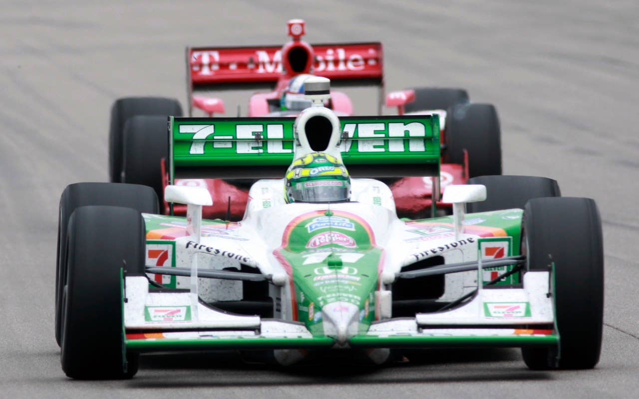 Tony Kanaan leads, of Brazil, leads Dario Franchitti, of Scotland, during the IndyCar Series' Iowa Corn Indy 250 auto race at Iowa Speedway in Newton, Iowa, Sunday, June 20, 2010. Kanaan won the race.