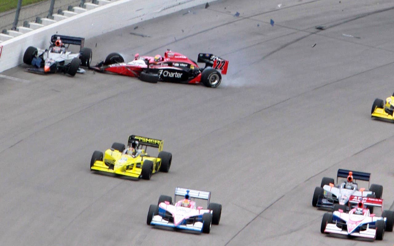 Mario Moraes, left, and Justin Wilson crash in turn four on the opening lap of the IndyCar Series' Iowa Corn Indy 250 auto race at Iowa Speedway in Newton, Iowa, Sunday, June 20, 2010.