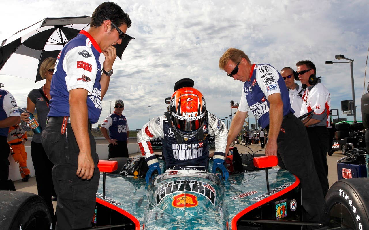 Dan Wheldon of England, driver of the #4 National Guard Panther Racing Dallara Honda, gets in to his car during qualifying for the IRL Indycar Series Iowa Corn Indy 250 on June 19, 2010 at the Iowa Speedway in Newton, Iowa.