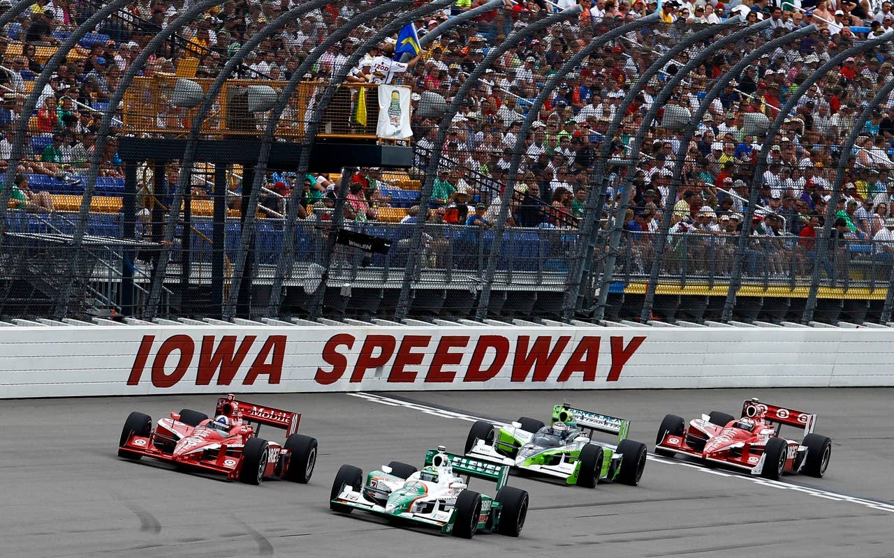 Tony Kanaan of Brazil, driver of the #11 7-Eleven Andretti Autosports Dallara Honda, leads Dario Franchitti of Scotland, driver of the #10 Target Chip Ganassi Racing Dallara Honda, during the IRL Indycar Series Iowa Corn Indy 250 on June 20, 2010 in Newton, Iowa.