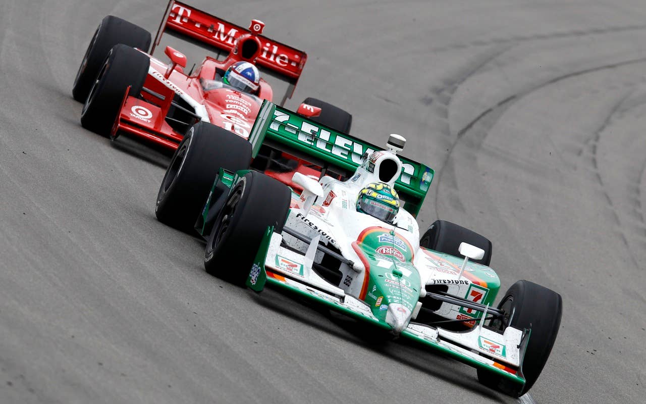 Tony Kanaan of Brazil, driver of the #11 7-Eleven Andretti Autosports Dallara Honda, leads Dario Franchitti of Scotland, driver of the #10 Target Chip Ganassi Racing Dallara Honda, during the IRL Indycar Series Iowa Corn Indy 250 on June 20, 2010 in Newton, Iowa.