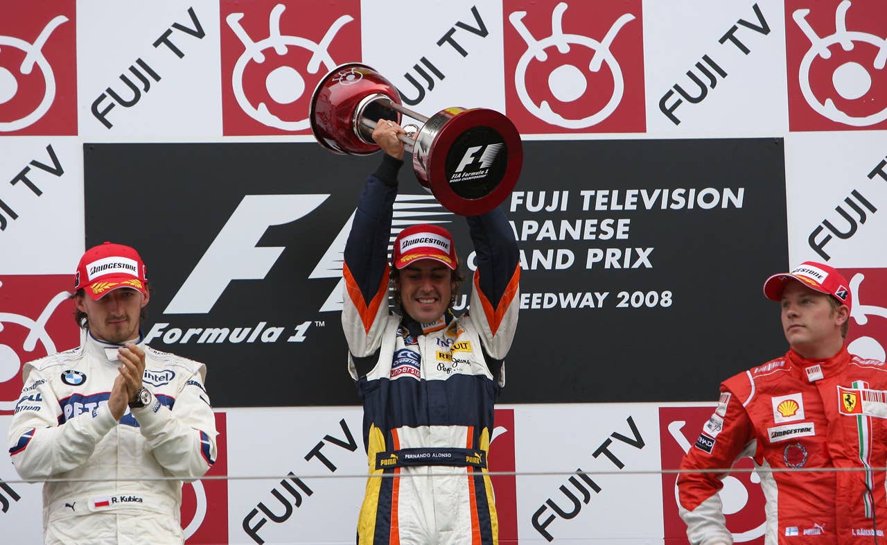 SHIZUOKA, JAPAN - OCTOBER 12: Race winner Fernando Alonso (C) of Spain and Renault celebrates on the podium with second placed Robert Kubica (L) of Poland and BMW Sauber and third placed Kimi Raikkonen (R) of Finland and Ferrari following Japanese Formula One Grand Prix at the Fuji Speedway on October 12, 2008 in Shizuoka, Japan. (Photo by Vladimir Rys/Bongarts/Getty Images)