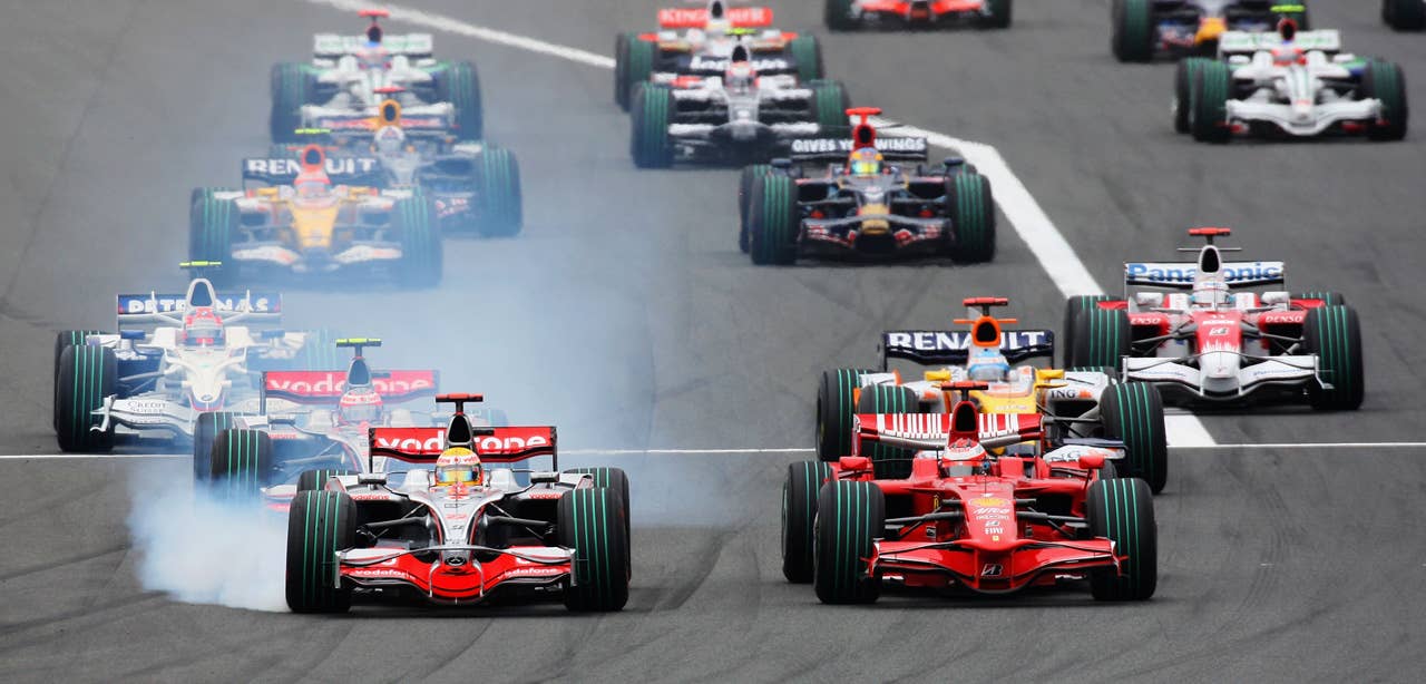 SHIZUOKA, JAPAN - OCTOBER 12: Lewis Hamilton (L) of Great Britain and McLaren Mercedes outbreaks Kimi Raikkonen (R) of Finland and Ferrari into the first corner at the start of the Japanese Formula One Grand Prix at the Fuji Speedway on October 12, 2008 in Shizuoka, Japan. (Photo by Mark Thompson/Getty Images)