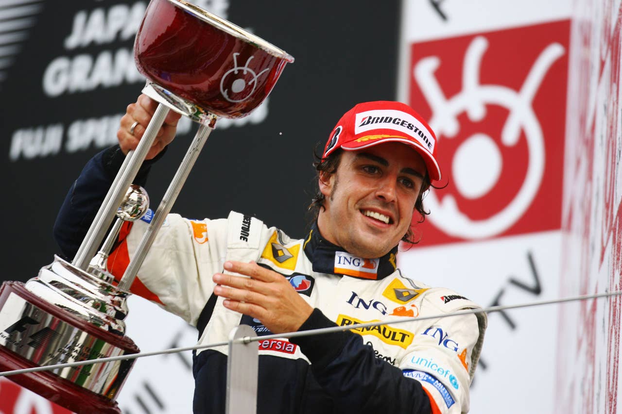 SHIZUOKA, JAPAN - OCTOBER 12: Fernando Alonso of Spain and Renault celebrates on the podium after winning the Japanese Formula One Grand Prix at the Fuji Speedway on October 12, 2008 in Shizuoka, Japan. (Photo by Clive Mason/Getty Images)