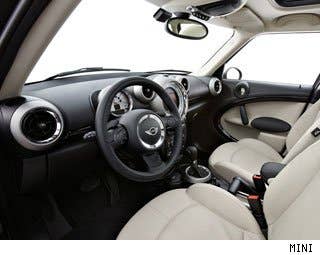 Despite the larger package in the Countryman, compared with the MINI Cooper, the interior of the crossover says MINI from stem to stern. The big speedometer is still intact incorporating Mini's navigation and infotainment screen, while the center stack has only been touched up, not completely redesigned from the MINI Cooper. The only major difference is the noticeably higher seating position, but it takes a matter of milliseconds to get used to the higher perch.  One rear seat configuration is offered in the Countryman: be offered: two bucket seats with a sliding track down the middle that can be configured to house either a cup holder or armrest. There's plenty of legroom and headroom for rear seat passengers, and the seats can be moved forward or backward, as well as recline or fold forward.  Research the MINI Countryman S MINI Countryman S Photos & Information MINI Countryman S Specs MINI Countryman S Local Dealer Price Quote