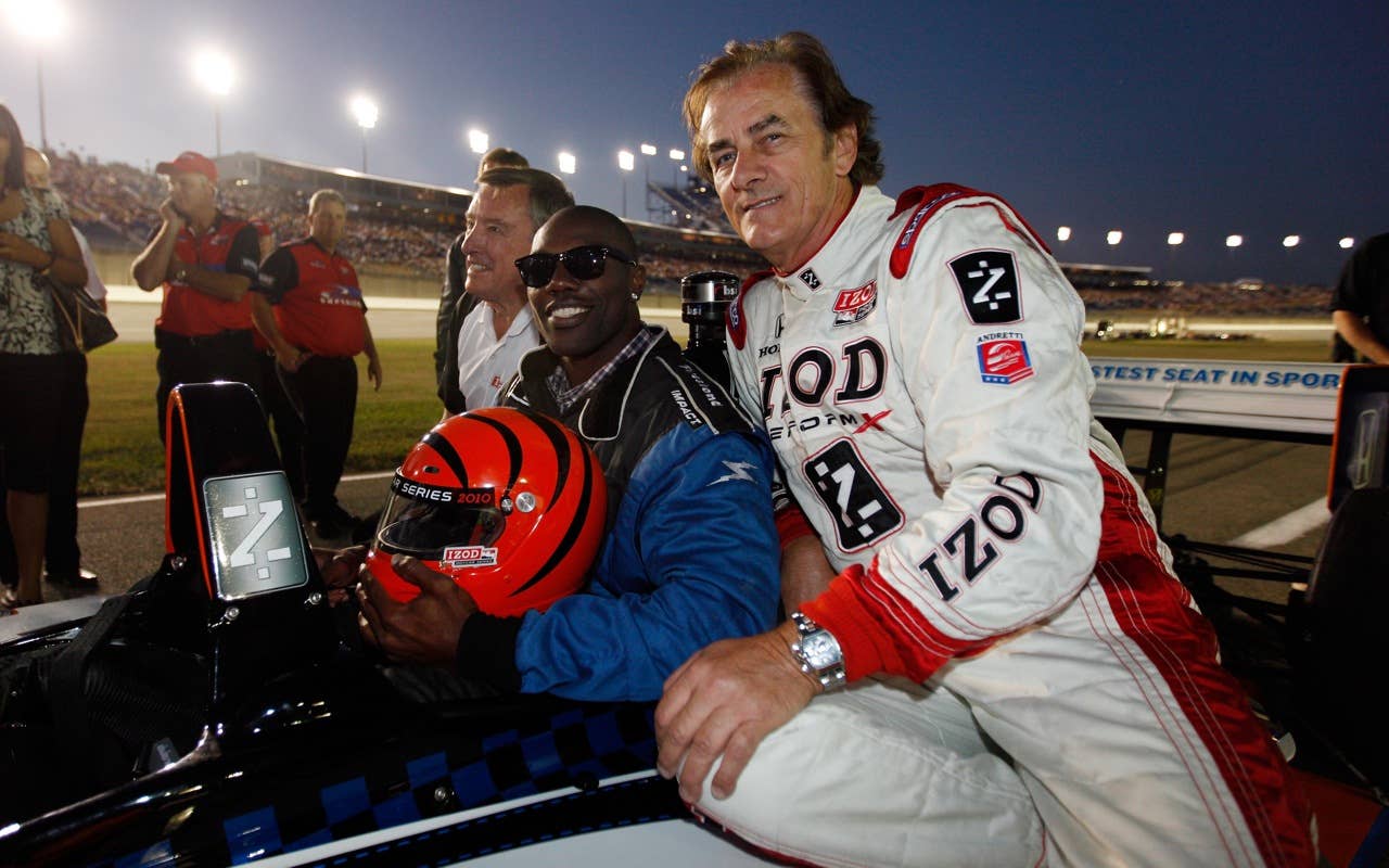 SPARTA, KY - SEPTEMBER 04:  Cincinnati Bengals wide reciever, Terrell Owens (L) talks with Arie Luyendyk has he prepares to ride in the two seat IndyCar at the front of the field before the start of the IndyCar Series Kentucky Indy 300 on September 4, 2010 in Sparta, Kentucky.  (Photo by Chris Graythen/Getty Images) *** Local Caption *** Terrell Owens;Arie Luyendyk
