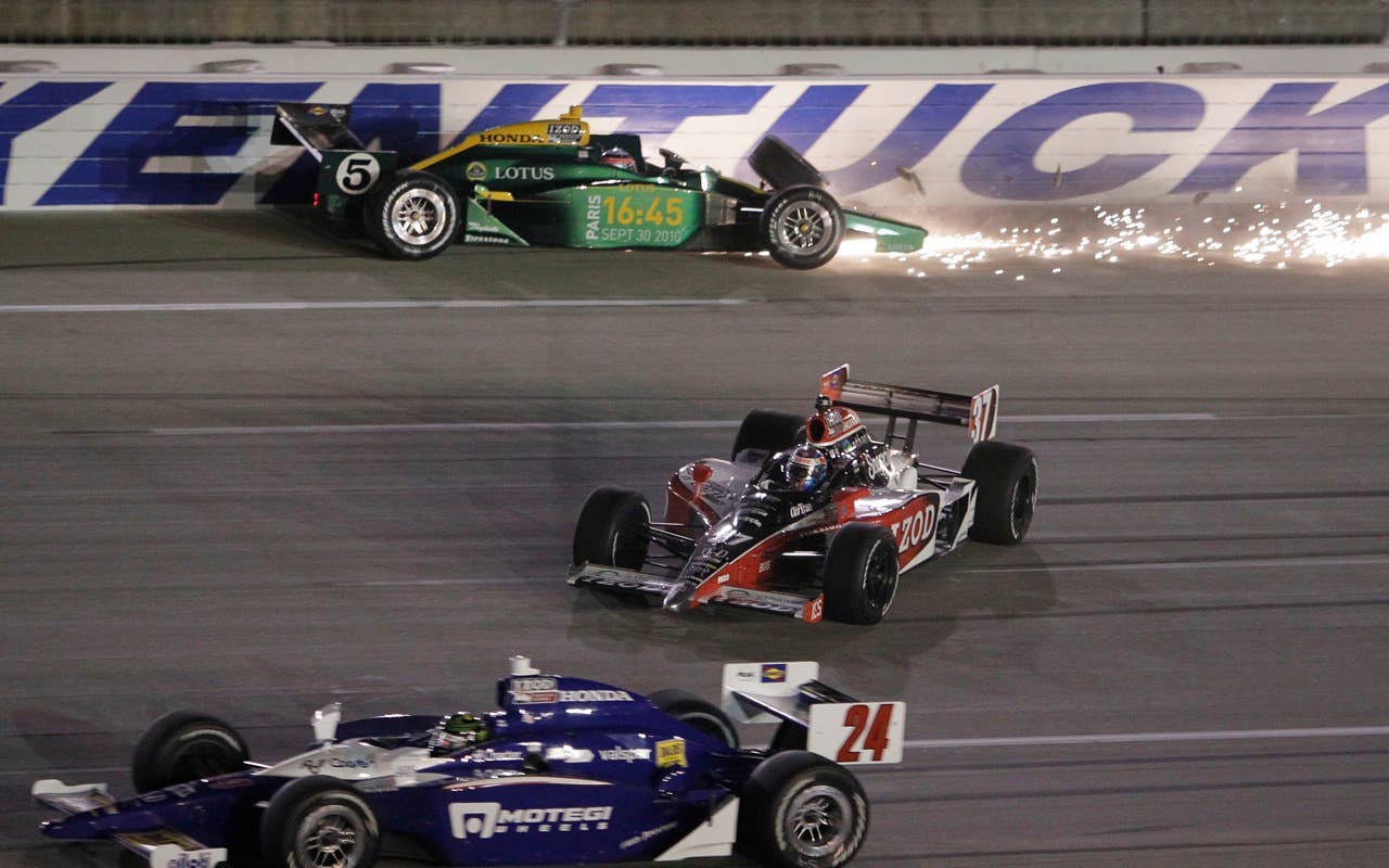 Paul Tracy (24) and Ryan Hunter-Reay (37) pass by as Takuma Sato (5) crashes into the wall on the opening lap of the IndyCar Series Kentucky Indy 300 auto race at the Kentucky Speedway in Sparta, Ky., Saturday, Sept. 4, 2010.  (AP Photo/Ed Reinke)