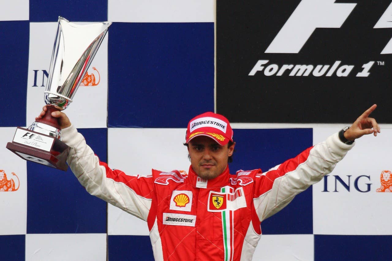 SPA FRANCORCHAMPS, BELGIUM - SEPTEMBER 07: Felipe Massa of Brazil and Ferrari celebrates on the podium after the Belgian Grand Prix at the Circuit of Spa Francorchamps on September 7, 2008 in Spa Francorchamps, Belgium. Lewis Hamilton of Mclaren Mercedes finished first but was then stripped of the victory after the stewards gave him a 25-second post-race penalty, handing victory to Massa, second place to Nick Heidfeld and demoting Hamilton to third position. (Photo by Ryan Pierse/Getty Images)