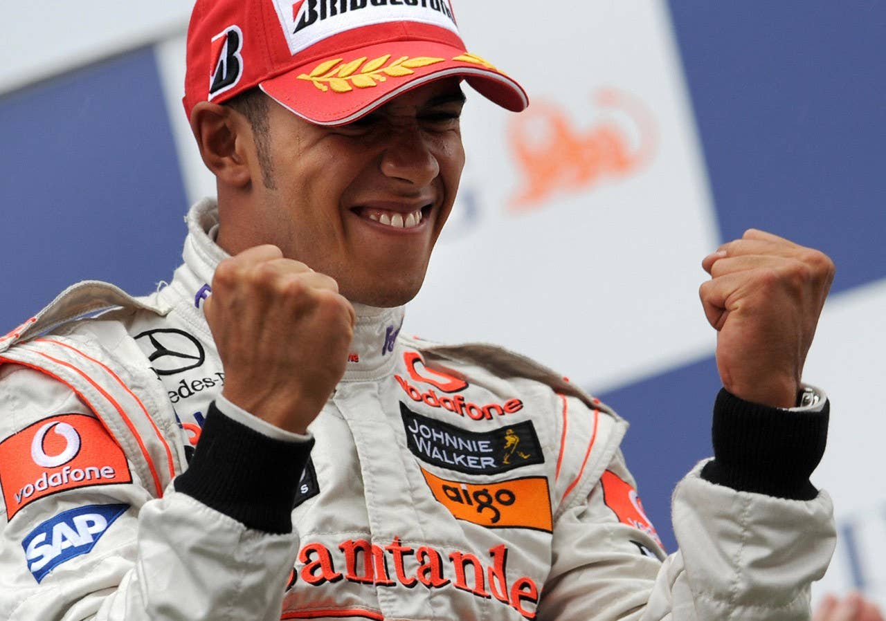 McLaren Mercedes' British driver Lewis Hamilton celebrates on the podium of the Spa-Francorchamps racetrack on September 7, 2008, after the Belgium Formula One Grand Prix. McLaren Mercedes' British driver Lewis Hamilton won the race ahead of Ferrari Brazilian's driver Felipe Massa and BMW Sauber's German driver Nick Heidfeld. AFP PHOTO / DENIS CHARLET (Photo credit DENIS CHARLET/AFP/Getty Images)