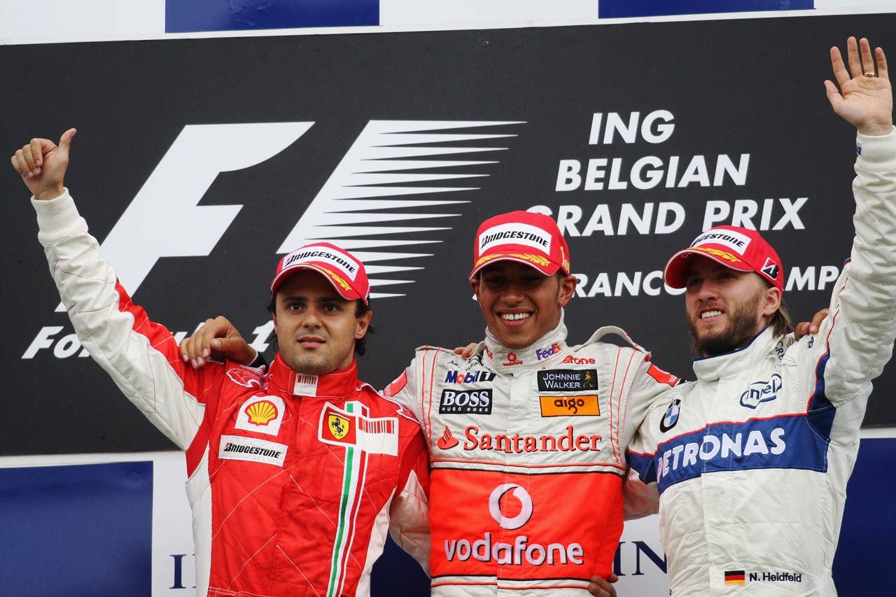 SPA FRANCORCHAMPS, BELGIUM - SEPTEMBER 07: Felipe Massa (L) of Brazil and Ferrari, Lewis Hamilton (C) of Great Britain and McLaren Mercedes and Nick Heidfeld (R) of Germany and BMW Sauber celebrate on the podium after the Belgian Grand Prix at the Circuit of Spa Francorchamps on September 7, 2008 in Spa Francorchamps, Belgium. Lewis Hamilton was then stripped of the victory after the stewards gave him a 25-second post-race penalty, handing victory to Felipe Massa, second place to Nick Heidfeld and demoting Hamilton to third position. (Photo by Bryn Lennon/Getty Images)