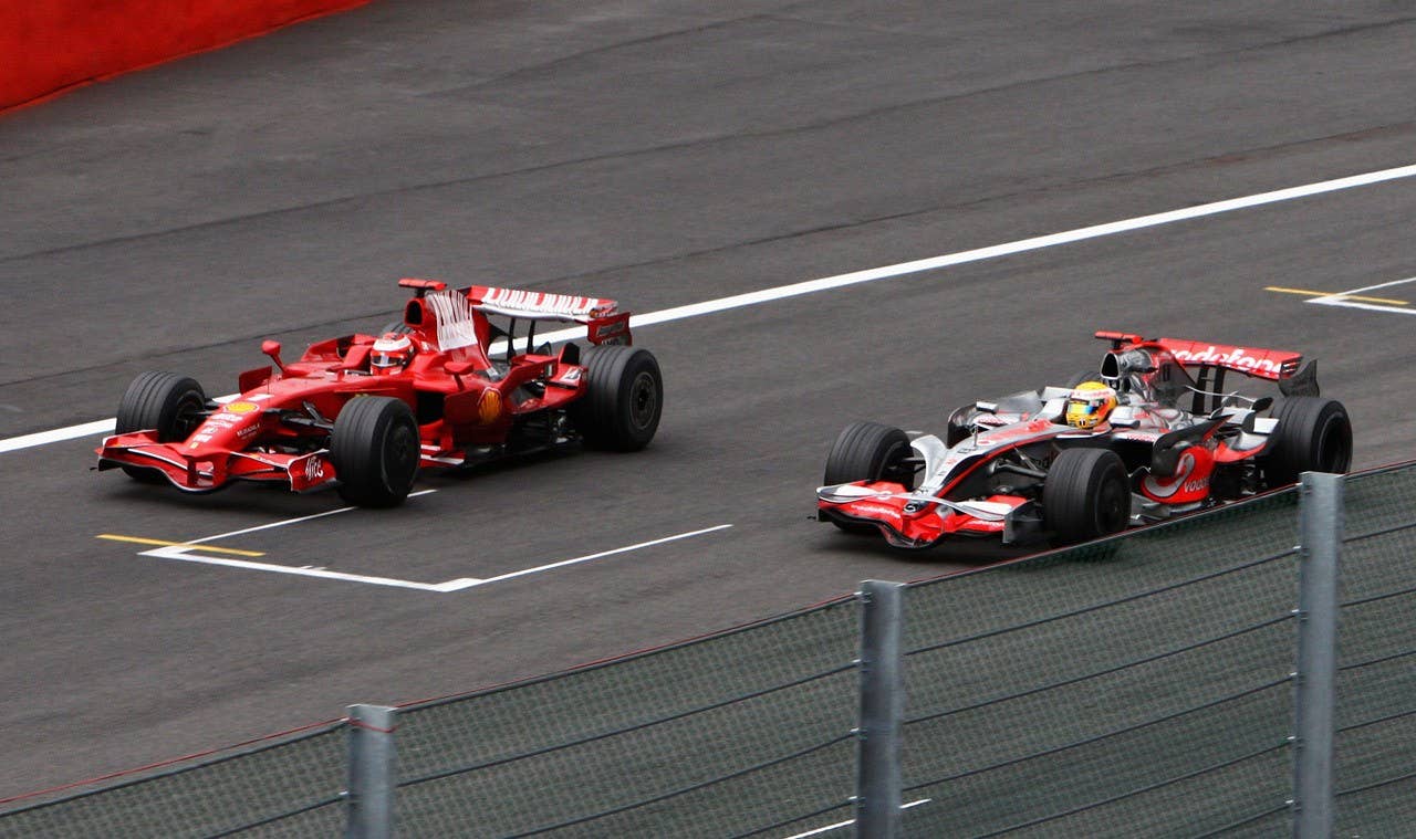 SPA FRANCORCHAMPS, BELGIUM - SEPTEMBER 07: Kimi Raikkonen (L) of Finland and Ferrari and Lewis Hamilton (R) of Great Britain and McLaren Mercedes run side by side during the Belgian Grand Prix at the Circuit of Spa Francorchamps on September 7, 2008 in Spa Francorchamps, Belgium. (Photo by Ryan Pierse/Getty Images)