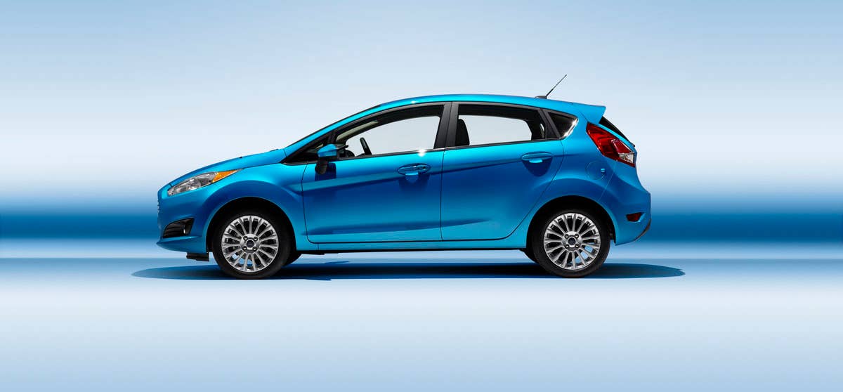 2014 Ford Fiesta 5dr: The 2014 Fiesta sports the stylish new face of Ford with a new grille, hood and tapered lines for a fun-to-drive look that makes customers want to get in and go. (11/26/2012)