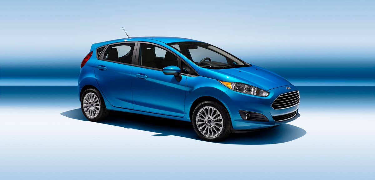 2014 Ford Fiesta 5dr: The 2014 Fiesta sports the stylish new face of Ford with a new grille, hood and tapered lines for a fun-to-drive look that makes customers want to get in and go. (11/26/2012)