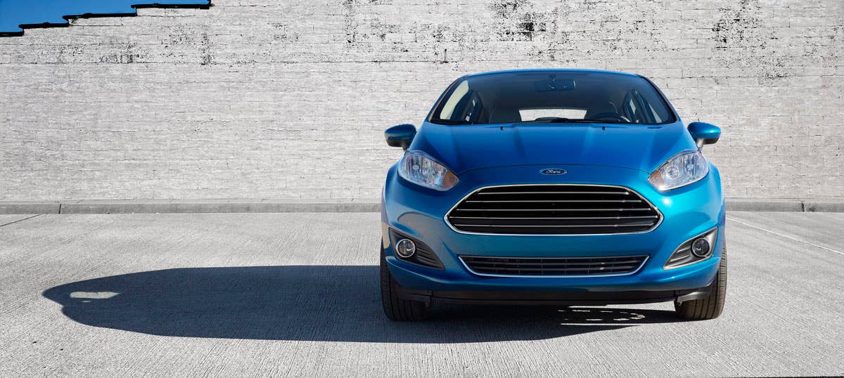 2014 Ford Fiesta 5dr: The 2014 Fiesta sports the stylish new face of Ford with a new grille, hood and tapered lines for a fun-to-drive look that makes customers want to get in and go. (11/26/2012)