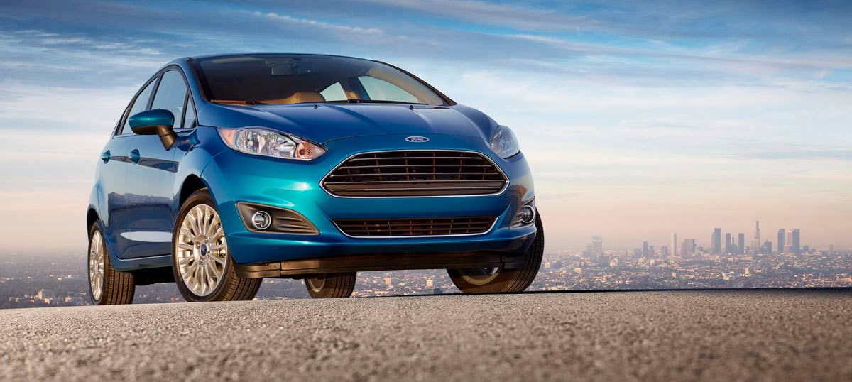 2014 Ford Fiesta 5dr: The 2014 Fiesta sports the stylish new face of Ford with a new grille, hood and tapered lines for a fun-to-drive look that makes customers want to get in and go. (11/27/2012)