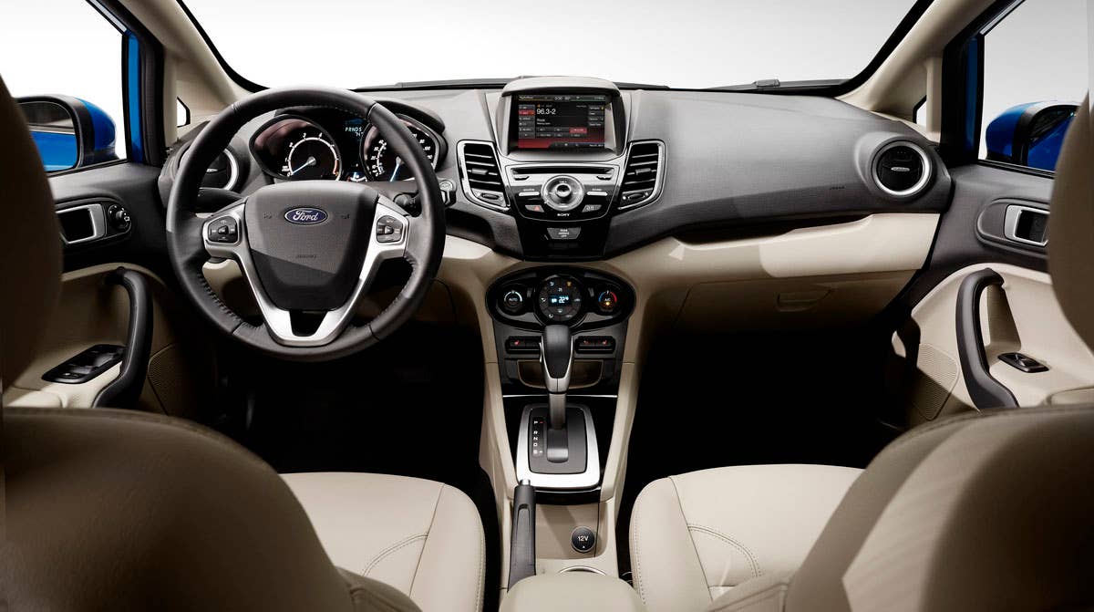 2014 Ford Fiesta 5dr: The Fiesta interior hosts one of the most comprehensive suites of in-car technologies with a cell phone-inspired dashboard and available 6.5-inch MyFord Touch screen. (11/26/2012)