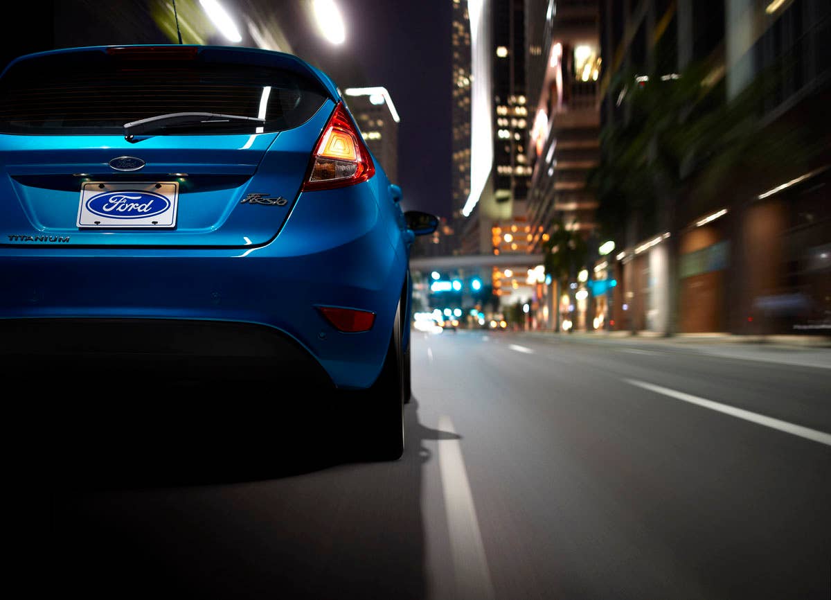 2014 Ford Fiesta 5dr: The 2014 Fiesta sports the stylish new face of Ford with a new grille, hood and tapered lines for a fun-to-drive look that makes customers want to get in and go. (11/26/2012)